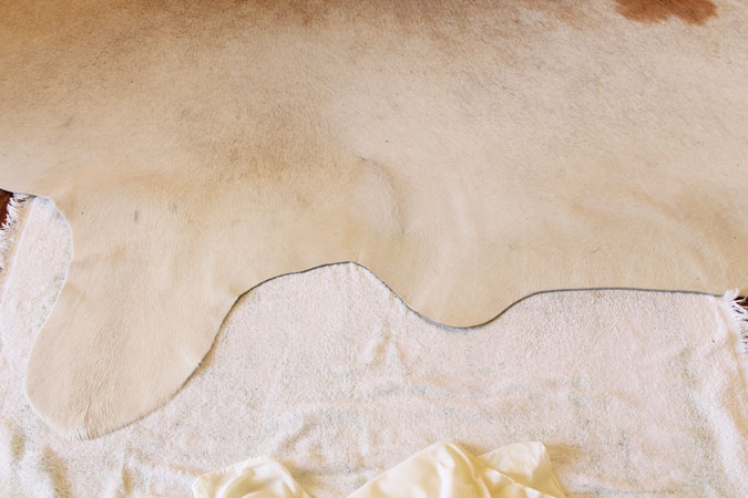 after ironing with damp cloth on top, wrinkles are gone from cowhide rug